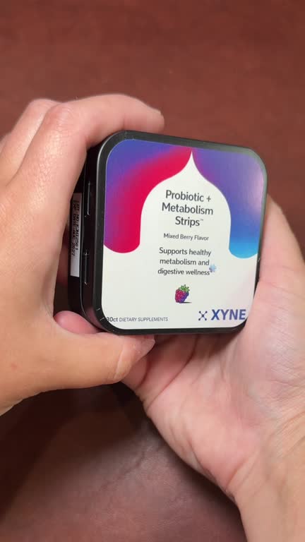 Hands open the Probiotic + Metabolism tin, take out a sachet and peel a strip from it