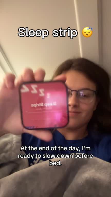 At the end of the day, a student holds up the Sleep Strips tin and places a strip on her tongue